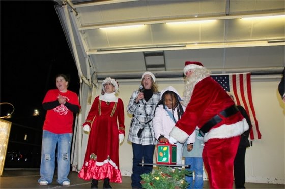 10-year-old Shyann Jones helps Borer light West Haven Green Christmas Tree
